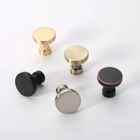 Five cabinet knobs in different finishes, including 10 Pack Brushed Brass Cabinet Knobs 1-1/4 Inch Gold Drawer Knobs for Kitchen Cabinets and Dressers.