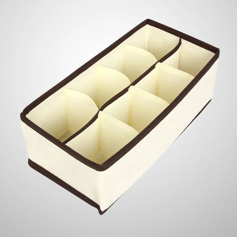 Top Tier Setup For Messy Drawers This Foldable Beige Drawer Organizer with eight compartments for sorting socks.