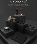Various espresso tools displayed on black podiums, including tamper, distributor, and tamping mat, promoting KYONANO espresso accessories.