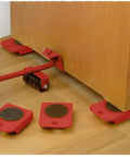 Heavy Duty Furniture Lifter Tool Set With Lifting Lever And Four Wheel Sliders in use under wooden cabinet