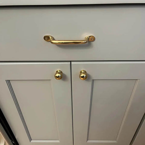 Unlacquered Solid Brass Cabinet Pull And Knob Set on white drawer, modern serene style, 7 inch length, heavy duty hardware