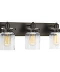 Calhoun Collection Clear Glass Farmhouse Bath Vanity Light Three Light Antique Bronze Finish With Thick Glass Shades Front View