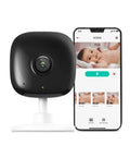 2K Plus Indoor Security Camera For Baby, Pets, And The Fam At Home adjacent to phone showing baby monitor app