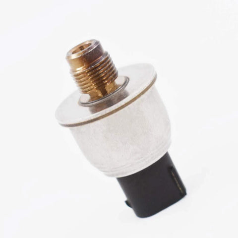 Master cylinder brake fluid pressure sensor close-up view; brass threaded fitting and silver metal body, black connector