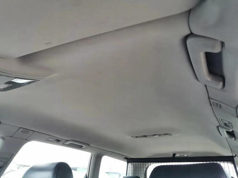 Installed light grey headliner fabric with foam backing in vehicle interior