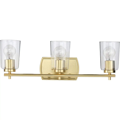 Adley Collection 3 Light Clear Glass Bath Vanity Light in Satin Brass, bar fixture with crystal clear glass shades, 23 in W.