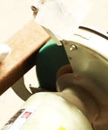 Home Run 8 Inch Green Non Woven Buffing And Polishing Wheels Pair mounted on a bench grinder for rust removal.