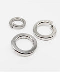 Beefed Up Stainless Steel Spring Lock Washer Kit With 1035 Pcs Assortment For M1.6 To M16 Sizes, 304 A2 70 Alloy, Prevents Loosening In Machinery Automotive Bikes And DIY Projects. close-up of stainless steel spring lock washers