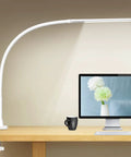 LED Desk Lamp With Clamp Workhorse Flexible Gooseneck Architect Table Lamp 5 Brightness Levels And 4 Color Modes Touch Control Eye Care 10W Desk Light For Home Office Reading White on a wood desk next to a computer screen and a mug.