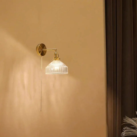 Wall Sconce Lights Indoor Bedroom Hallway Vintage Glass with Pull Chain,Industrial Adjustable Fixture,Brass Lamp for Living Room,E27 Base mounted on wall with clear glass shade.