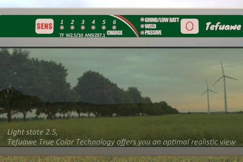Hand Series 2x4 Digital Auto Darkening Welding Lens showing settings and view with trees and wind turbines, ideal for low amp TIG welding.