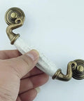 Drop Bail Dresser Drawer Pulls White Crackle Ceramic Knobs With Antique Bronze Finish, 5.5 Inch Length, held in hand view