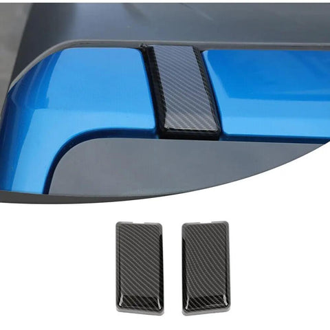 Slick Carbon Fiber Top Screws Protector Cover Trim Cap For 2021 Plus Vehicles, two carbon look screw caps on blue vehicle roof.