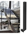 Top Tier Black Glass Railing Kit With Stainless Steel Deck Support Rock Solid Glass Clamps For Smooth No Hassle Custom Height Setup Totally Elevate Your Outdoor Vibes, showcasing a modern staircase with glass panels.