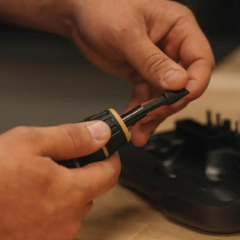 Person holding a Manual Firearms Torque Wrench With Inch-Pounds Readout, Bits, And Rugged Storage Case For Scope Mounts, Gunsmithing.
