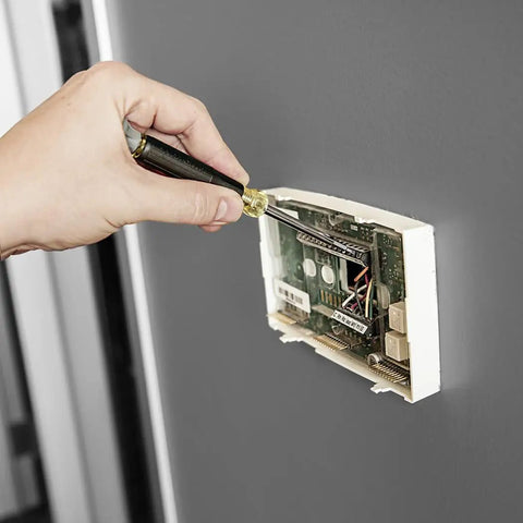 Hand using Magnetic 11 In 1 Screwdriver And Nut Driver Kit With Stubby And Electronics Drivers 3 Piece Set to fix wall panel