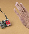 60GHz Pulsed Radar Breakout A111 With Integrated Antenna Single Chip PCR Radar Solution SPI Interface Up To 50MHz High Precision Distance Motion And Gesture Sensing For DIY Projects board beside hand