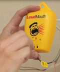 Hand holding LoudMouth Monitor Fault Detector for Indoor Electric Heating Tape Mats and Underfloor Heating Installations, Yellow Unit.