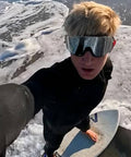 Person surfing wearing Frameless Ultralight Black Mirror Swim Goggles With VisiClear Nanotech Anti Fog Lens And 100 Percent UV Protection
