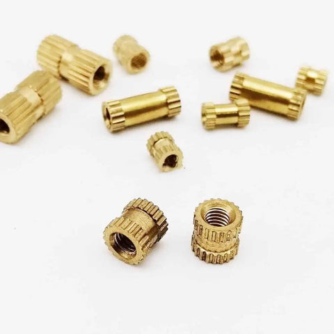 25 Pack Solid Brass Knurl Insert Nuts M2 M2.5 M3 Metric Threads Round Shape OD Options For Heavy Duty Projects And Tight Fits scattered on a white background.