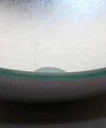 Close-up of the smooth glass basin from Artistic Tempered Glass Oval Vessel Sink Above Counter with Chrome Faucet and Pop Up Drain