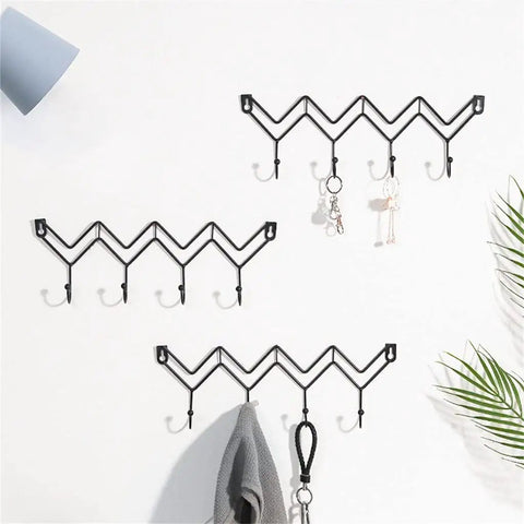 Black Wrought Iron Wall Mount Coat Hooks With Smooth Polish Heavy Duty Key Hangers Vibe Up Your Living Room Or Bedroom Setup on a white wall.