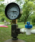Front view of pool filter pressure gauge with 2-inch dial on brass valve and PVC fittings