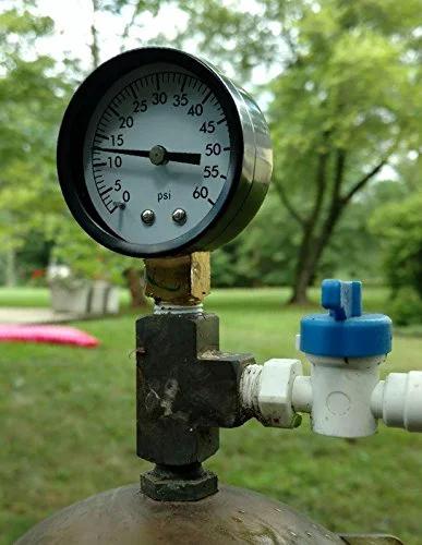Front view of pool filter pressure gauge with 2-inch dial on brass valve and PVC fittings