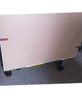 Heavy Duty Drywall Lifter And Gypsum Board Handler With Adjustable Rock Solid Grip carrying a large gypsum board.