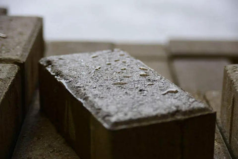 Concrete brick block with wet look finish showcasing Heavy Duty Wet Look Paver Sealer For Concrete And Brick Blocks Rain UV Damage.