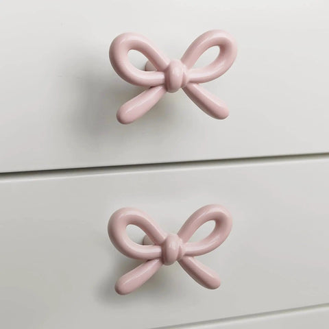 Snag These Premium Vintage Pink Bow Cabinet Knobs 6 Pack Farmhouse Traditional Solid Metal Drawer Pulls on white drawers.