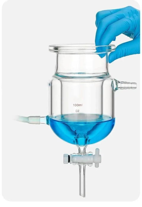 Close-up of 100ml clear glass vessel with blue liquid, showing PTFE diverter valve for Heavy Duty Three Port Double Jacketed Open Reactor.