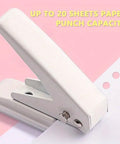 Heavy Duty Single Hole Puncher With One Quarter Inch Hole Twenty Sheet Capacity Metal Construction on pink background
