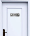 Genuine Stainless Steel Authorized Personnel Only Sign 3 By 9 Inches on a white door background.