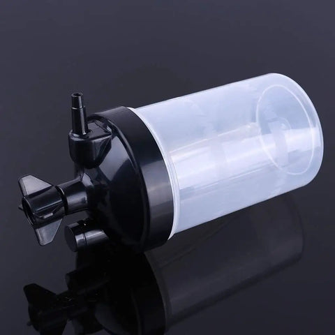 Oxygen Humidifier Bubbler Bottle 350ml with built-in pressure relief valve lying on its side, clear plastic construction.