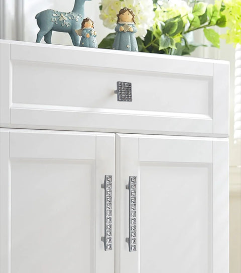 White cabinet with Crystal Glass Rhinestone Cabinet Pulls 4 Pack Shiny Dresser Knobs Handles for cupboard doors.