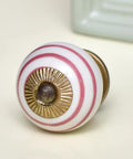 Straight Up Top Tier 100 Piece White Ceramic Drawer Knobs With Slick Stripe Detailing For Kitchen Cabinets Dressers And Closets close-up view of a striped ceramic knob.