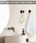 Black pipe hooks with towel and sponge from Industrial Style 10 Piece Bathroom Hardware Set Boss Black Finish Includes 18 Inch And 25 Inch Towel Bars Round Towel Ring Dual Toilet Paper Holders Four Robe Hooks Wall Mounted Bath Kit.