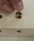 Person inserting barrel nut into wood for Hella Sturdy M6x100mm Bunk Bed Bolts Compatible With Ikea Bed Frames.