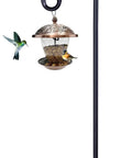 62 Inch Outdoor Shepherds Hook Bird Feeder Pole With 5 Prongs Base, shown holding a lantern with a hummingbird feeder attached.