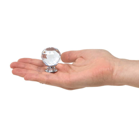 Hand holding one 42mm round crystal knob from the Crystal Knobs Set Six Pack Round Ball 42mm Cabinet Knobs With Screws For Dresser Drawers Cabinets