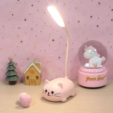 Kids Cat Desk Lamp with Flexible Gooseneck LED Eye Care Light for Homework and Reading in pink, surrounded by decor items.