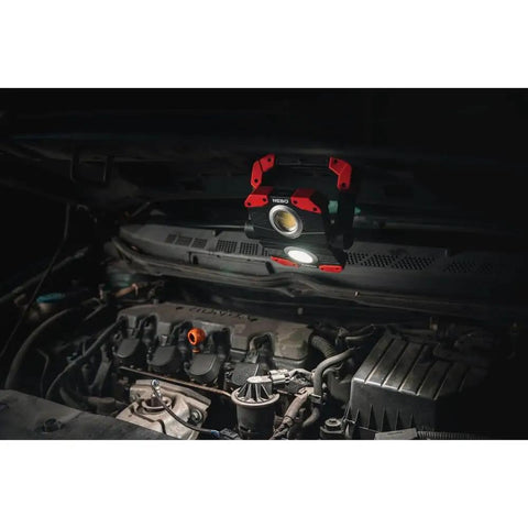 Omni 2K Rechargeable Work Light With 2000 Lumens Six Light Modes illuminating car engine with magnetic handle.