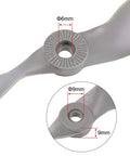 Close-up of RC Propellers 10x7 Inch Two Vane Nylon Gray for Airplane Pack of 3 With Adapter Rings showing 6mm and 9mm adapter sizes