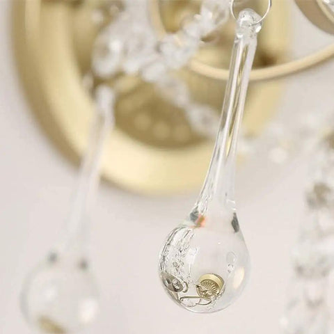 Close-up of a clear crystal drop from a Modern Crystal Wall Sconce With E27 Socket For Bedroom And Living Room.