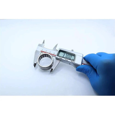 Built Tough One Way Needle Roller Bearing Drawn Cup Clutch 30x37x20mm being measured with caliper for precise sizing.
