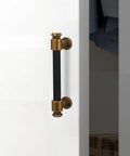 10 Pack Black And Antique Brass Knurled Cabinet Pulls For Kitchen Cabinets Center To Center 96mm, shown installed on white door
