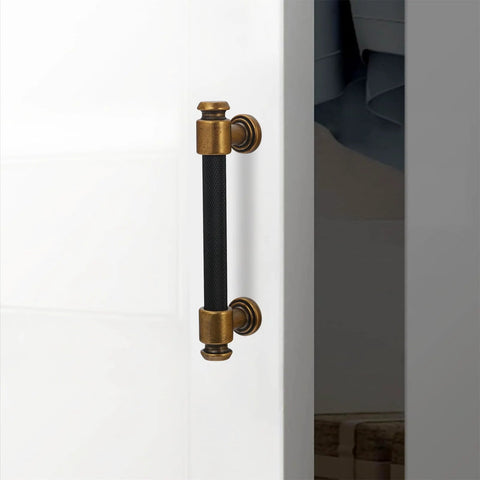 10 Pack Black And Antique Brass Knurled Cabinet Pulls For Kitchen Cabinets Center To Center 96mm, shown installed on white door