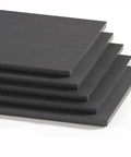 Stacked black PEEK boards for heavy duty projects, 30x500mm size, anti-static and fiber reinforced for high temperature use.