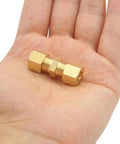 Hand holding brass compression fittings ice maker connector